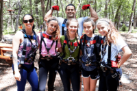 Five Girls & Man Flexing Behind Them