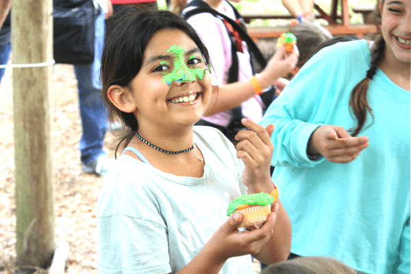 Young Child Has Cupcake on Her Face