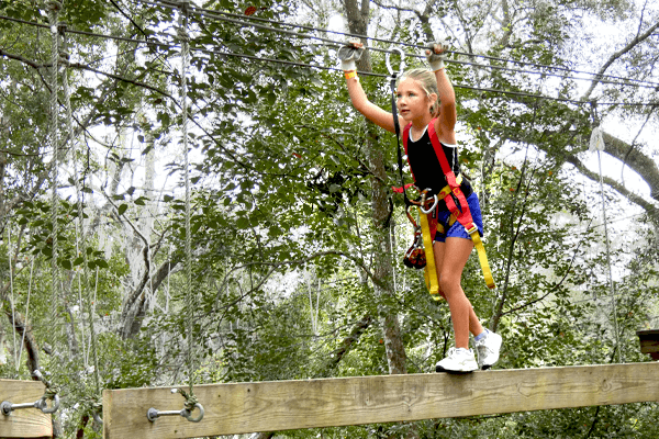 Young Guest Walks Beam On Forest Run Course