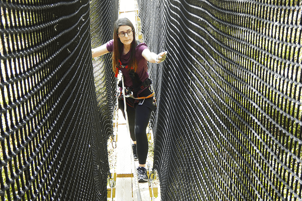 Woman Crosses Mountain Trail Course