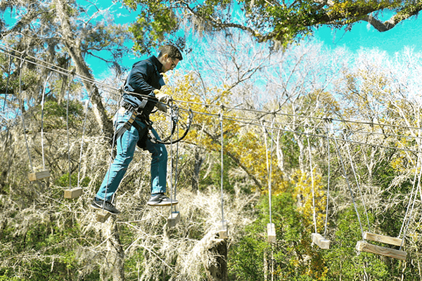 Man Traverses Hanging Steps on Mountain Trail Course
